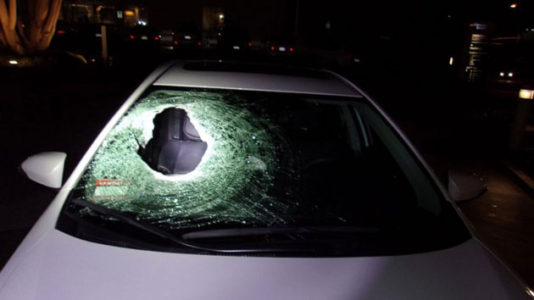 Boulder thrown from overpass kills young man in car with his family