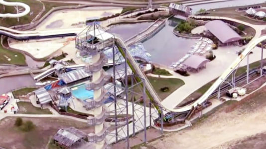 Designer of waterslide that killed boy surrenders to police after returning to country