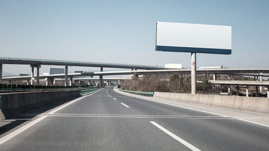 Out-of-control truck smashes light poles after climbing highway median