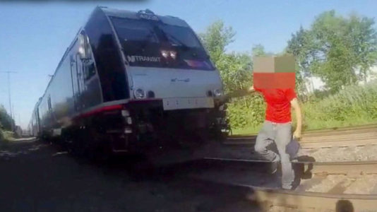 Bodycam footage shows officer saving man just seconds from being hit by oncoming train