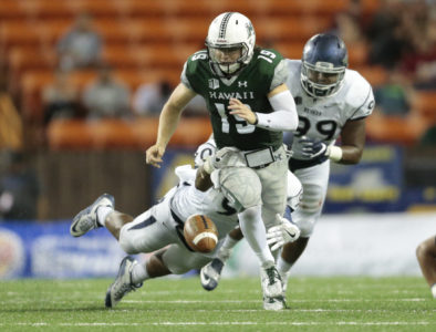 2016 October 1 SPT - HSA Photo by Jamm Aquino.
Hawaii quarterback Dru Brown (19) fumbles the football after a hit from Nevada defensive end Malik Reed (90) and defensive end Korey Rush (99) during the second half of a college football game between the Hawaii Rainbow Warriors and the Nevada Wolf Pack on Saturday, October 1, 2016 at Aloha Stadium in Honolulu.  Hawaii won 38-17.