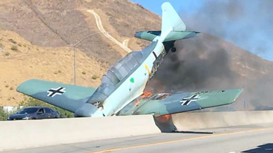 Vintage plane erupts in flames after crashing onto freeway in Southern California