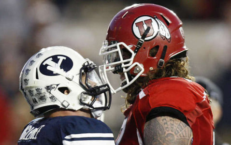 Brigham Young Cougars linebacker Brandon Ogletree (44) and Utah Utes offensive linesman John Cullen (77) get in each other's face as BYU and Utah play Saturday, Sept. 17, 2011