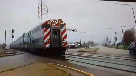 Dash cam shows Illinois police officer narrowly avoid being hit by speeding train