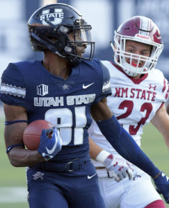 Utah State's Savon Scarver (81) returns a kickoff 100 yards for a touchdown as New Mexico State defensive back Ron LaForce (23) chases him during an NCAA college football game Saturday, Sept. 8, 2018, in Logan, Utah. (Eli Lucero/The Herald Journal via AP)