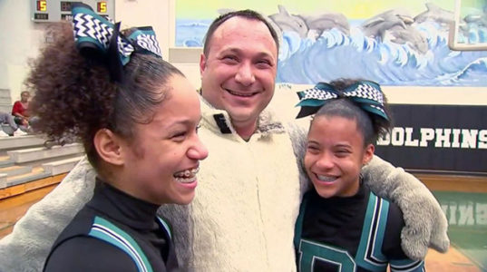 Sisters burst into tears as school mascot is revealed to be military dad