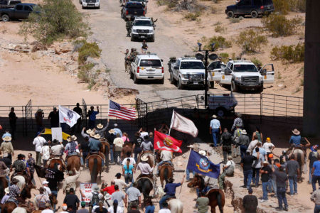 Protesters gather at the Bureau of Land Management's base camp, where cattle that were seized from rancher Cliven Bundy are being held, near Bunkerville, Nevada April 12, 2014. The U.S. Bureau of Land Management on Saturday said it had called off an effort to round up Bundy's herd of cattle that it had said were being illegally grazed in southern Nevada, citing concerns about safety. The conflict between Bundy and U.S. land managers had brought a team of armed federal rangers to Nevada to seize the 1,000 head of cattle. REUTERS/Jim Urquhart   (UNITED STATES - Tags: ANIMALS CIVIL UNREST AGRICULTURE CRIME LAW)