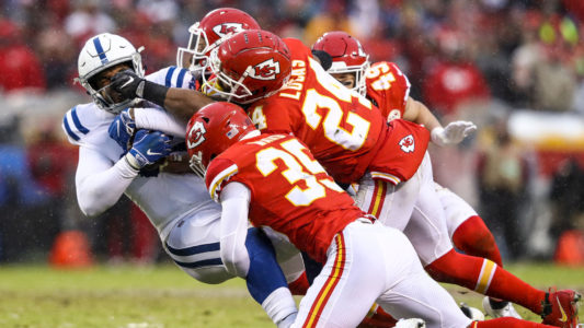 KANSAS CITY, MO - JANUARY 12: Eric Ebron #85 of the Indianapolis Colts is tackled by Charvarius Ward #35 and Jordan Lucas #24 of the Kansas City Chiefs during the first quarter of the AFC Divisional Round playoff game at Arrowhead Stadium on January 12, 2019 in Kansas City, Missouri. (Photo by Jamie Squire/Getty Images)
