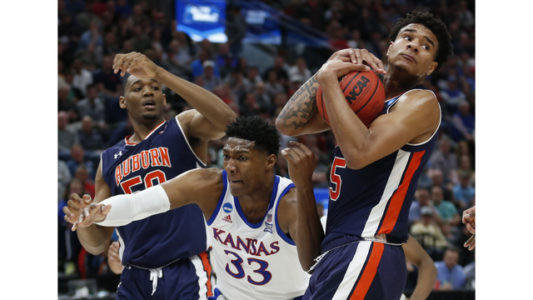 Auburn's Chuma Okeke (5) grabs a rebound from Kansas forward David McCormack (33) as Auburn's Austin Wiley (50) watches during the first half of a second-round game in the NCAA men's college basketball tournament Saturday, March 23, 2019, in Salt Lake City. (AP Photo/Rick Bowmer)