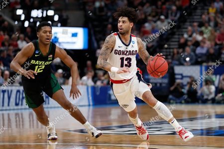 Mandatory Credit: Photo by Jeff Swinger/AP/Shutterstock (10165158b)
Gonzaga guard Josh Perkins (13) drives to the hoop past Baylor guard Jared Butler (12) during the first half of a second-round game in the NCAA men's college basketball tournament, in Salt Lake City
NCAA Baylor Gonzaga Basketball, Salt Lake City, USA - 23 Mar 2019