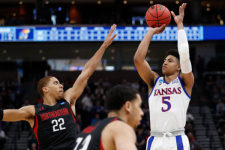 Northeastern guard Donnell Gresham Jr. (22) defends as Kansas guard Quentin Grimes (5) shoots in the first half during a first round men's college basketball game in the NCAA Tournament, Thursday, March 21, 2019, in Salt Lake City. (AP Photo/Jeff Swinger)
