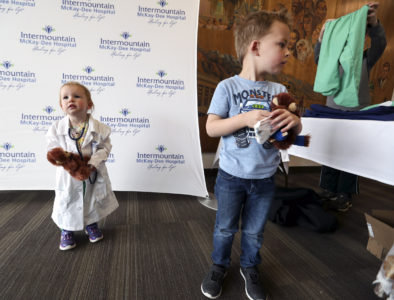 Emery Heywood, 2, and her brother, Teagen, 4, put on hospital clothes, for a picture as they attended the Teddy Bear Clinic and Picnic, with their mother Kailey Heywood, at McKay-Dee Hospital in Ogden on Wednesday, March 27, 2019. Children were given Teddy bears and took them to their own doctorÕs visit. The Teddy Bear Clinic is meant to help teach the importance of health to kids.