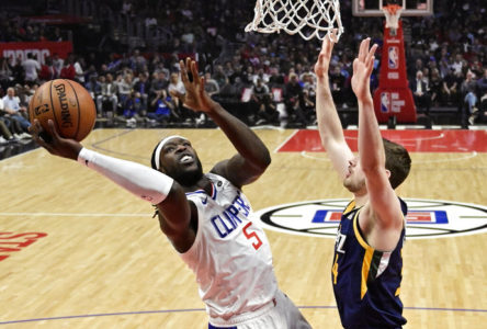 Los Angeles Clippers forward Montrezl Harrell, left, shoots as Utah Jazz forward Tyler Cavanaugh defends during the first half of an NBA basketball game Wednesday, April 10, 2019, in Los Angeles. (AP Photo/Mark J. Terrill)