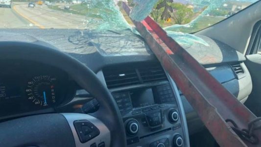Woman unharmed after metal beam smashes through windshield