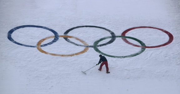 FILE - In this Feb. 10, 2018, file photo, a worker grooms the snow after installing a set of Olympic Rings on the ski jump hill at the 2018 Winter Olympics at the Alpensia Ski Jumping Center in Pyeongchang, South Korea. Does anyone really want to host the Winter Olympics? Residents in Calgary answered that question with a resounding "No," and now the International Olympic Committee has some soul-searching to do. (AP Photo/Charlie Riedel, File)