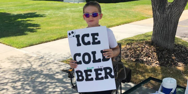 Seth Parker holding beer sign.