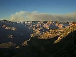Helicopter dropping water onto wildfire on North rim
