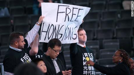 Activists hold up a sign before an NBA preseason basketball game between the Washington Wizards and the Guangzhou Loong-Lions, Wednesday, Oct. 9, 2019, in Washington. (AP Photo/Nick Wass)