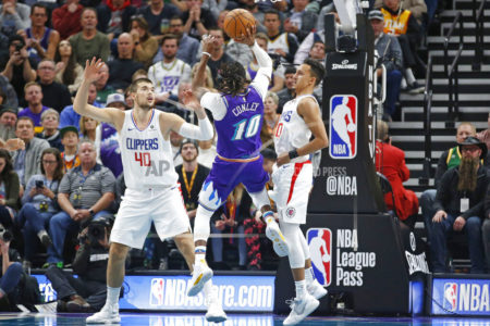 Utah Jazz guard Mike Conley (10) shoots as Los Angeles Clippers' Ivica Zubac (40) and Landry Shamet (20) defend during the first half of an NBA basketball game Wednesday, Oct. 30, 2019, in Salt Lake City. (AP Photo/Rick Bowmer)