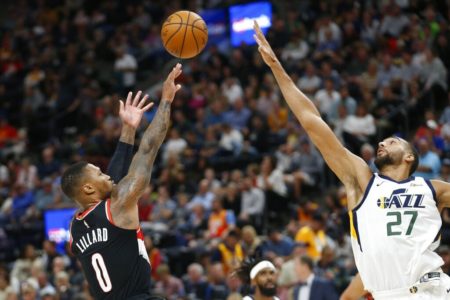 Portland Trail Blazers guard Damian Lillard (0) shoots over Utah Jazz center Rudy Gobert (27) in the second half of a preseason NBA basketball game Wednesday, Oct. 16, 2019, in Salt Lake City. (AP Photo/Rick Bowmer)