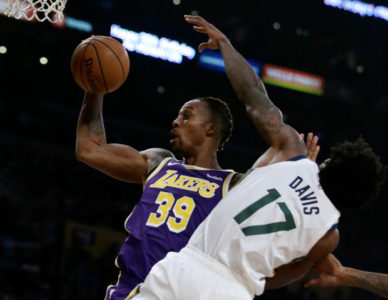 Los Angeles Lakers center Dwight Howard, left, rebounds the ball next to Utah Jazz center Ed Davis during the first half of an NBA basketball game in Los Angeles, Friday, Oct. 25, 2019. (AP Photo/Alex Gallardo)