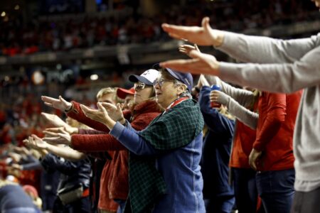 FILE - In this Oct. 25, 2019, file photo, fans gesture the baby shark as Washington Nationals' Gerardo Parra bats during the sixth inning of Game 3 of the baseball World Series against the Houston Astros, in Washington. Creators of the viral video “Baby Shark,” whose “doo doo doo” song was played at the World Series in October, are developing a version in Navajo. (AP Photo/Patrick Semansky, File) ORG XMIT: FX204