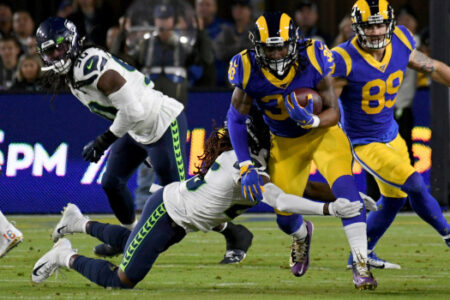 The Rams' Todd Gurley #30 escapes the tackle of the Seahawks’ Shaquill Griffin #26 during their NFL game at the Los Angeles Memorial Coliseum in Los Angeles, Sunday, Dec. 8, 2019. (Photo by Hans Gutknecht, Los Angeles Daily News/SCNG)