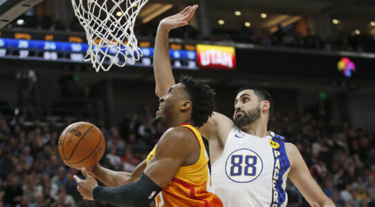Utah Jazz guard Donovan Mitchell, left, lays the ball up as Indiana Pacers center Goga Bitadze (88) defends in the second half during an NBA basketball game Monday, Jan. 20, 2020, in Salt Lake City. (AP Photo/Rick Bowmer)