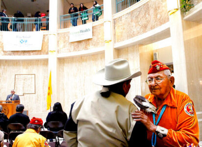 FILE - In this Feb. 4, 2011, file photo, Leland Anthony, Arizona Rep. for Indian Health Incorp., left, speaks with Navajo code talker Joe Vandever Sr. during Native American Day at the roundhouse in Santa Fe, New Mexico. One of the few remaining Navajo Code Talkers who used their native language to confound the Japanese in World War II has died. Joe Vandever Sr. died of health complications Friday, Jan. 31, 2020, in Haystack, New Mexico, west of Grants, according to his family. He was 96. Tribal leaders called Vandever a "great warrior" and a "compassionate family man," and asked Navajos to keep his spirit and his family in their prayers. (Jane Phillips/The New Mexican via AP)