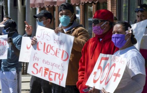 Workers march after virus outbreak at Utah meatpacking plant