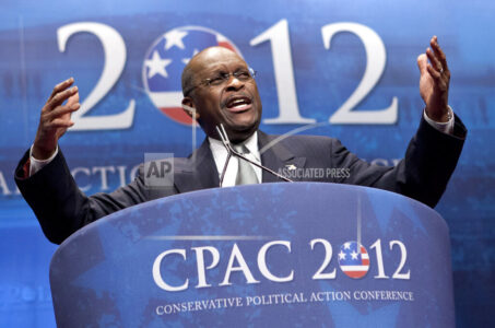 FILE - In this Feb. 9, 2012 file photo, former presidential candidate Herman Cain addresses the Conservative Political Action Conference in Washington.  Cain has died after battling the coronavirus. A post on Cain's Twitter account on Thursday, July 30, 2020 announced the death.   (AP Photo/J. Scott Applewhite, File)