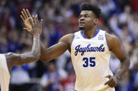 FILE - In this Feb. 3, 2020, file photo, Kansas center Udoka Azubuike (35) is congratulated after a dunk against Texas during the second half of an NCAA college basketball game in Lawrence, Kan. Azubuike was selected by the Utah Jazz in the NBA draft Wednesday, Nov. 18, 2020. (AP Photo/Reed Hoffmann, File)