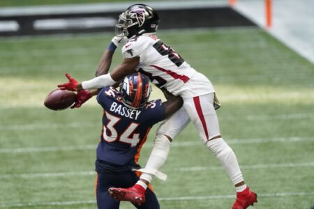 Atlanta Falcons wide receiver Russell Gage (83) misses the catch against Denver Broncos defensive back Essang Bassey (34) during the second half of an NFL football game, Sunday, Nov. 8, 2020, in Atlanta. (AP Photo/John Bazemore)