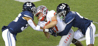 New Mexico wide receiver Andrew Erickson (87) is tacked by Utah State safety Jared Reed (36) and cornerback Cam Lampkin (6) during the first half of an NCAA college football game Thursday, Nov. 26, 2020, in Logan, Utah. (Eli Lucero/The Herald Journal via AP)