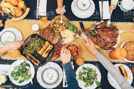 Overhead view of big family eating from table during Christmas dinner