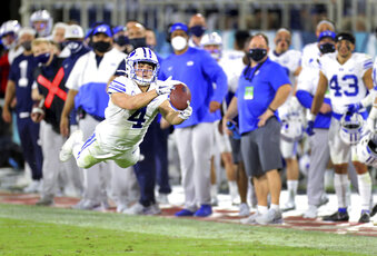 BYU's Troy Warner stretches out for a catch late in the second quarter against Central Florida in the Boca Raton Bowl NCAA college football game Tuesday, Dec. 22, 2020, in Boca Raton, Fla. (Mike Stocker/South Florida Sun-Sentinel via AP)