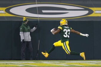 Green Bay Packers' Aaron Jones runs for a touchdown during the first half of an NFL football game against the Carolina Panthers Saturday, Dec. 19, 2020, in Green Bay, Wis. (AP Photo/Matt Ludtke)