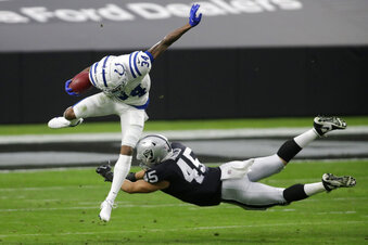 Indianapolis Colts cornerback Isaiah Rodgers (34) jumps over Las Vegas Raiders fullback Alec Ingold (45) during the first half of an NFL football game, Sunday, Dec. 13, 2020, in Las Vegas. (AP Photo/Isaac Brekken)
