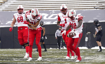 Utah running back Ty Jordan, right, celebrates after his touchdown run with, from left, offensive lineman Jaren Kump and wide receivers Solomon Enis and Bryan Thompson in the second half of an NCAA college football game against Colorado, Saturday, Dec. 12, 2020, in Boulder, Colo. Utah won 38-21. (AP Photo/David Zalubowski)