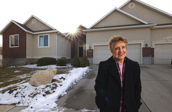 Madelene Lee poses for a photo outside of her home in West Jordan, Utah, on Wednesday, Dec. 16, 2020. She and her husband supplement their income by renting out their basement to a couple and by hosting foreign exchange students. (Scott G Winterton/The Deseret News via AP)