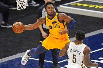 Utah Jazz guard Donovan Mitchell (45) passes the ball as New Orleans Pelicans guard Eric Bledsoe (5) watches during the first half of an NBA basketball game Tuesday, Jan. 19, 2021, in Salt Lake City. (AP Photo/Rick Bowmer)