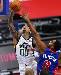 Detroit Pistons guard Wayne Ellington (8) attempts to block a shot by Utah Jazz guard Jordan Clarkson (00) during the first half of an NBA basketball game, Sunday, Jan. 10, 2021, in Detroit. (AP Photo/Carlos Osorio)