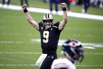 New Orleans Saints quarterback Drew Brees (9) reacts after a touchdown by Alvin Kamara in the second half of an NFL wild-card playoff football game against the Chicago Bears in New Orleans, Sunday, Jan. 10, 2021. (AP Photo/Butch Dill)