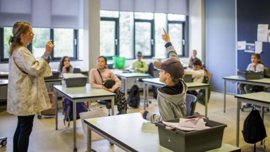 Teacher Marie Kaas-Larsen questions her pupils in a classroom rearrangered for social distancing at the Norrebro Park primary school in Copenhagen, Denmark on April 29, 2020. - Denmark was the first country in Europe to reopen its schools for the youngest pupils on April 15. In addition to practicing social distancing and regular handwashing, classes must be held outdoors as much as possible to limit the spread of the virus. (Photo by Thibault Savary / AFP) / The erroneous mention[s] appearing in the metadata of this photo by Thibault Savary has been modified in AFP systems in the following manner: [April 29, 2020] instead of [April 30, 2020]. Please immediately remove the erroneous mention[s] from all your online services and delete it (them) from your servers. If you have been authorized by AFP to distribute it (them) to third parties, please ensure that the same actions are carried out by them. Failure to promptly comply with these instructions will entail liability on your part for any continued or post notification usage. Therefore we thank you very much for all your attention and prompt action. We are sorry for the inconvenience this notification may cause and remain at your disposal for any further information you may require. (Photo by THIBAULT SAVARY/AFP via Getty Images)