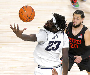 Utah State center Neemias Queta (23) reaches out for a rebound as San Diego State guard Jordan Schakel (20) defends during the first half of an NCAA college basketball game Saturday, Jan. 16, 2021, in Logan, Utah. (Eli Lucero/The Herald Journal via AP, Pool)