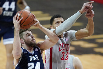 Utah State's Rollie Worster (24) shoots against UNLV's Nicquel Blake (22) during the first half of an NCAA college basketball game against Utah State, Wednesday, Jan. 27, 2021, in Las Vegas. (AP Photo/John Locher)