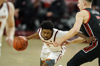 Southern California's Tahj Eaddy, left, is pressured by Utah's Pelle Larsson during the second half of an NCAA college basketball game, Saturday, Jan. 2, 2021, in Los Angeles. USC won 64-46. (AP Photo/Jae C. Hong)