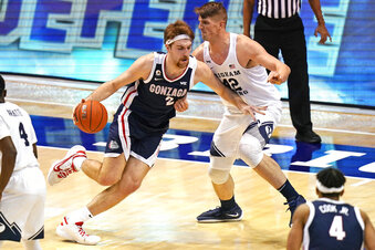 Gonzaga forward Drew Timme (2) drives as BYU center Richard Harward (42) defends in the first half of an NCAA college basketball game, Monday, Feb. 8, 2021, in Provo, Utah. (AP Photo/Rick Bowmer)