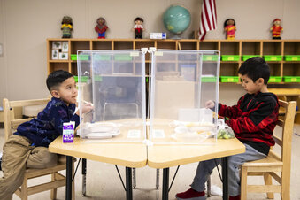 FILE - In this Jan. 11, 2021, file photo, preschool students eat lunch at Dawes Elementary in Chicago. Pressure is building on school systems around the U.S. to reopen classrooms to students who have been learning online for nearly a year, pitting politicians against teachers who have yet to be vaccinated against COVID-19. (Ashlee Rezin Garcia/Chicago Sun-Times via AP, Pool, File)