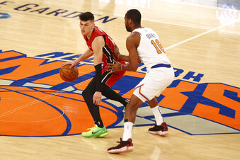 Alec Burks, right,  of the New York Knicks defends against Tyler Herro, left, of the Miami Heat during an NBA basketball game on Sunday, Feb. 7, 2021, in New York City. (Mike Stobe/Pool Photo via AP)